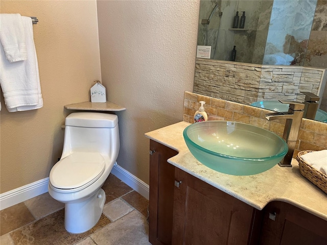 full bathroom with walk in shower, baseboards, toilet, vanity, and stone tile flooring