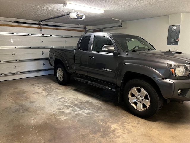 garage with electric panel and a garage door opener