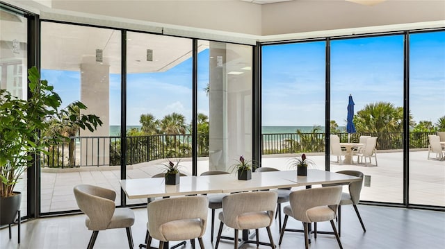 1211 Gulf Of Mexico Dr Unit 309, Longboat Key, FL 34228 - dining space featuring a water view and a wall of windows