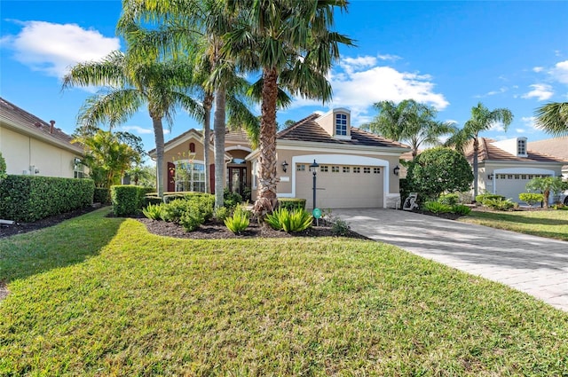 11716 Strandhill Ct, Lakewood Ranch, FL 34202 - view of front of home featuring a tile roof, stucco siding, an attached garage, driveway, and a front lawn