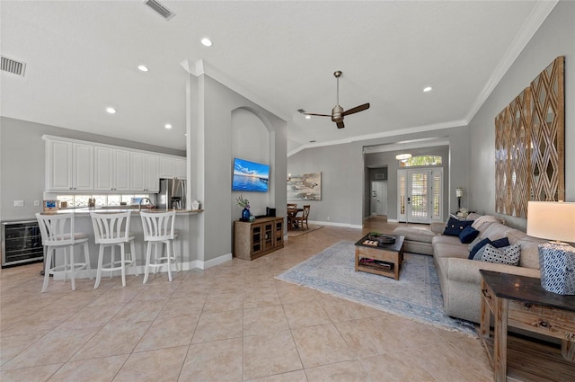 11716 Strandhill Ct, Lakewood Ranch, FL 34202 - living area with light tile patterned flooring, crown molding, wine cooler, visible vents, and ceiling fan