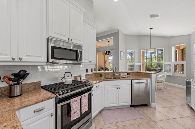 11716 Strandhill Ct, Lakewood Ranch, FL 34202 - kitchen featuring decorative backsplash, visible vents, appliances with stainless steel finishes, a sink, and light tile patterned floors