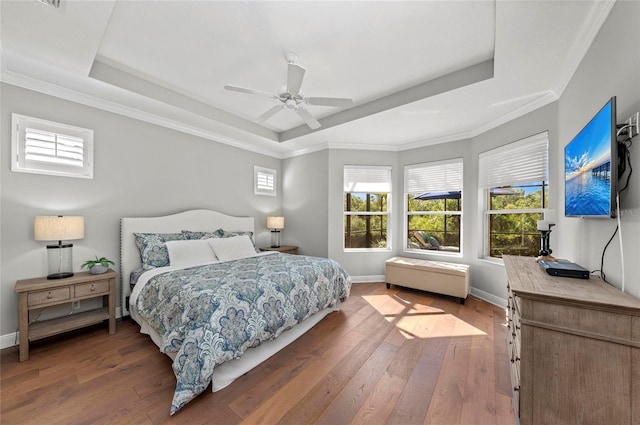 11716 Strandhill Ct, Lakewood Ranch, FL 34202 - bedroom featuring wood-type flooring, ceiling fan, baseboards, and a raised ceiling