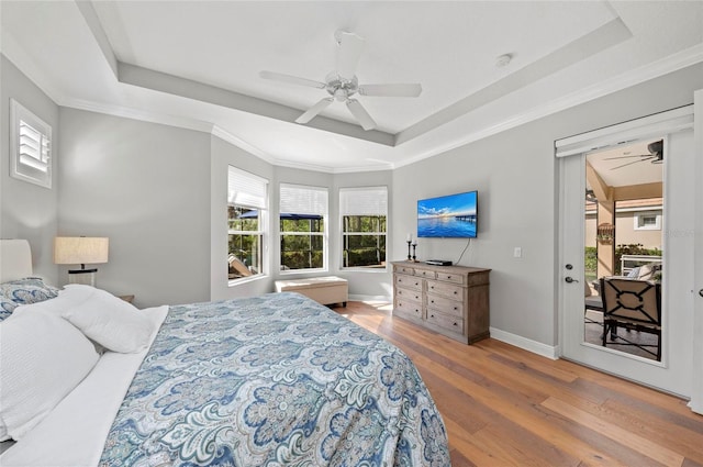 11716 Strandhill Ct, Lakewood Ranch, FL 34202 - bedroom with baseboards, access to outside, wood finished floors, a ceiling fan, and a raised ceiling