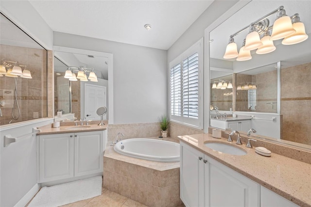 11716 Strandhill Ct, Lakewood Ranch, FL 34202 - full bathroom with two vanities, tile patterned flooring, a sink, and a garden tub