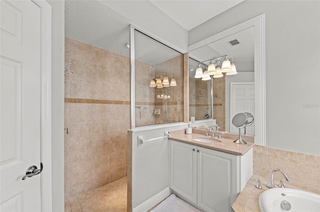 11716 Strandhill Ct, Lakewood Ranch, FL 34202 - full bathroom featuring vanity, a walk in shower, a bath, and visible vents