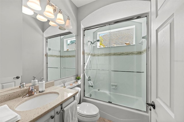 11716 Strandhill Ct, Lakewood Ranch, FL 34202 - full bathroom with toilet, shower / bath combination with glass door, and vanity