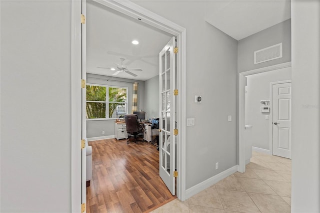 11716 Strandhill Ct, Lakewood Ranch, FL 34202 - corridor featuring baseboards, visible vents, and light tile patterned floors