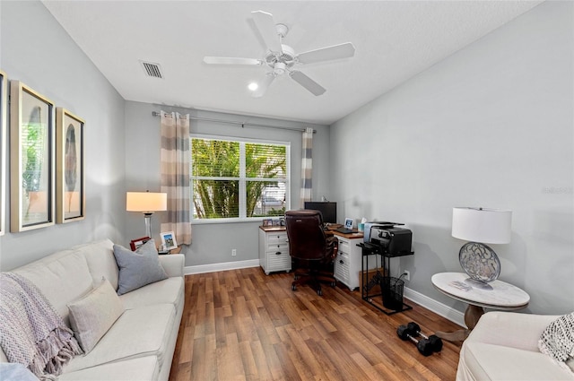 11716 Strandhill Ct, Lakewood Ranch, FL 34202 - home office with visible vents, baseboards, ceiling fan, and wood finished floors
