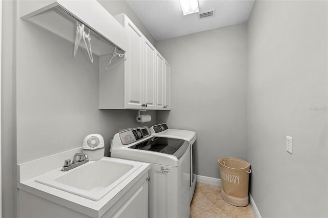 11716 Strandhill Ct, Lakewood Ranch, FL 34202 - clothes washing area featuring light tile patterned floors, a sink, visible vents, cabinet space, and washer and dryer