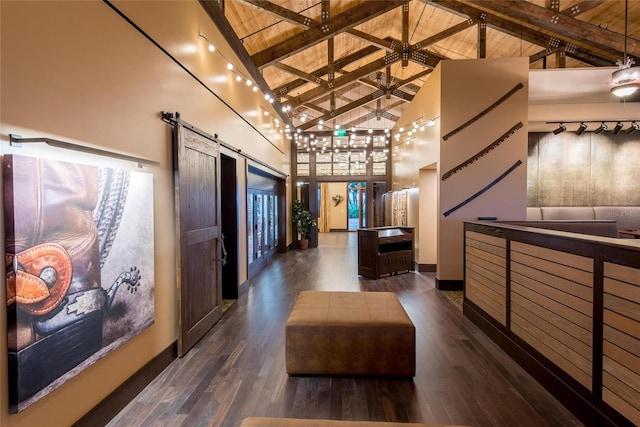 11716 Strandhill Ct, Lakewood Ranch, FL 34202 - hall featuring high vaulted ceiling, wood finished floors, beam ceiling, a barn door, and wood ceiling
