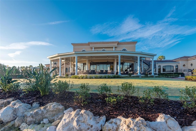 11716 Strandhill Ct, Lakewood Ranch, FL 34202 - back of house featuring a lawn, a tile roof, and stucco siding