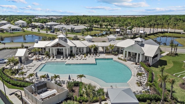 community pool with a water view, a patio, fence, a gazebo, and a residential view