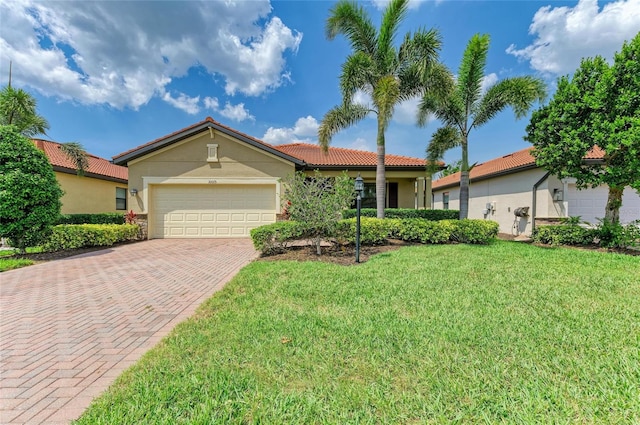 10015 Marbella Dr, Bradenton, FL 34211 - view of front facade featuring decorative driveway, stucco siding, a front lawn, and a garage