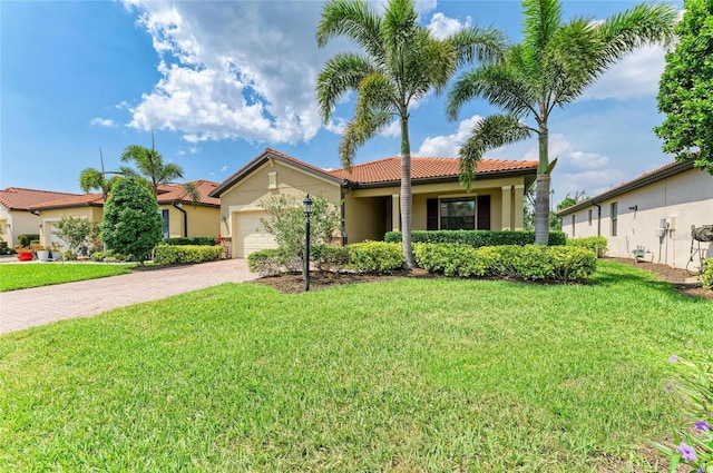 10015 Marbella Dr, Bradenton, FL 34211 - view of front of home with a tile roof, decorative driveway, stucco siding, and a front yard