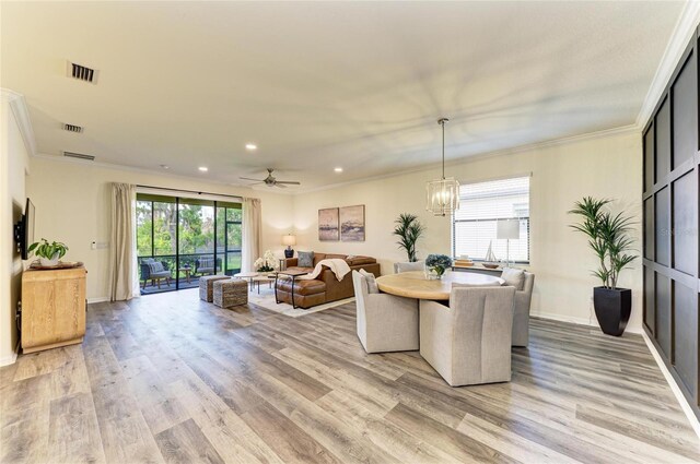 10015 Marbella Dr, Bradenton, FL 34211 - dining area featuring light wood-style floors, ornamental molding, recessed lighting, a ceiling fan, and a chandelier