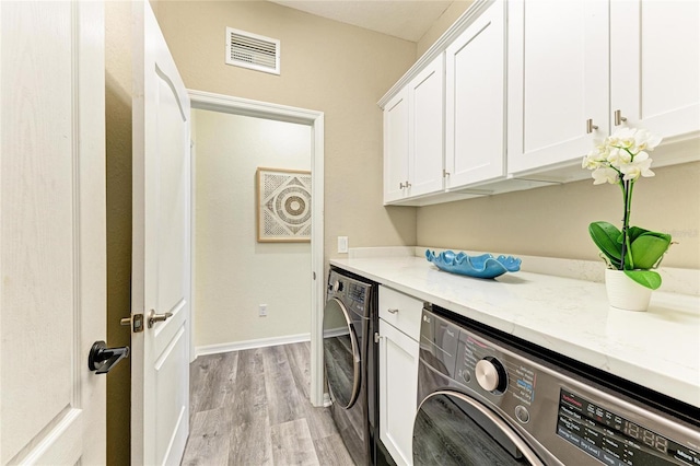 10015 Marbella Dr, Bradenton, FL 34211 - washroom with cabinet space, light wood-type flooring, and washer and clothes dryer