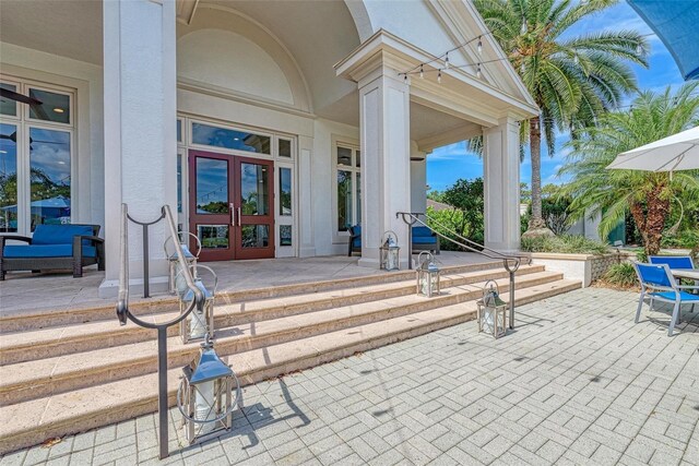 10015 Marbella Dr, Bradenton, FL 34211 - entrance to property with french doors, stucco siding, and a porch
