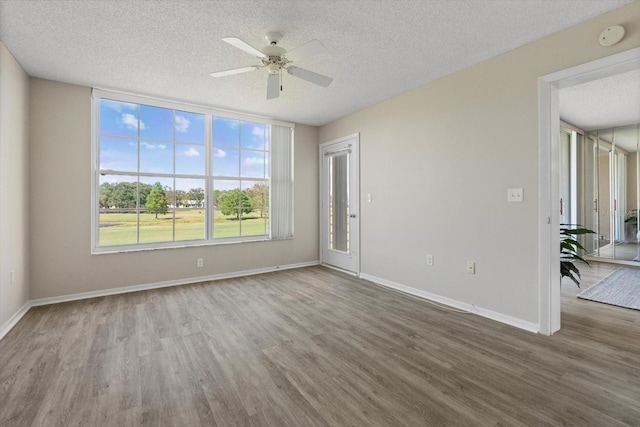 4440 Fairways Blvd Unit 210, Bradenton, FL 34209 - empty room featuring baseboards, wood finished floors, ceiling fan, and a textured ceiling