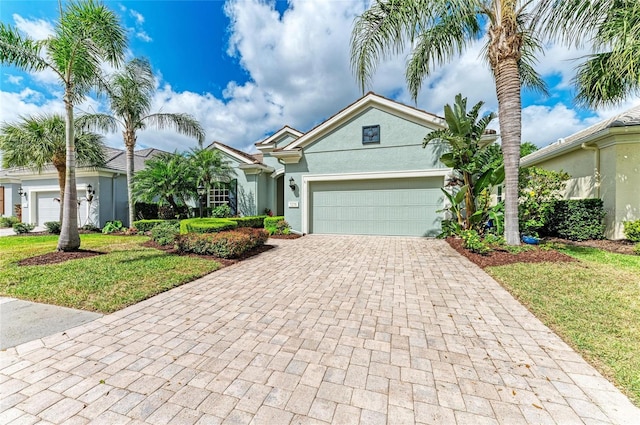 7278 Lismore Ct, Lakewood Ranch, FL 34202 - single story home with decorative driveway, a garage, stucco siding, and a front yard