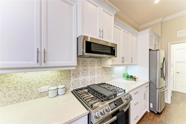7278 Lismore Ct, Lakewood Ranch, FL 34202 - kitchen featuring stainless steel appliances, ornamental molding, white cabinets, dark wood finished floors, and decorative backsplash