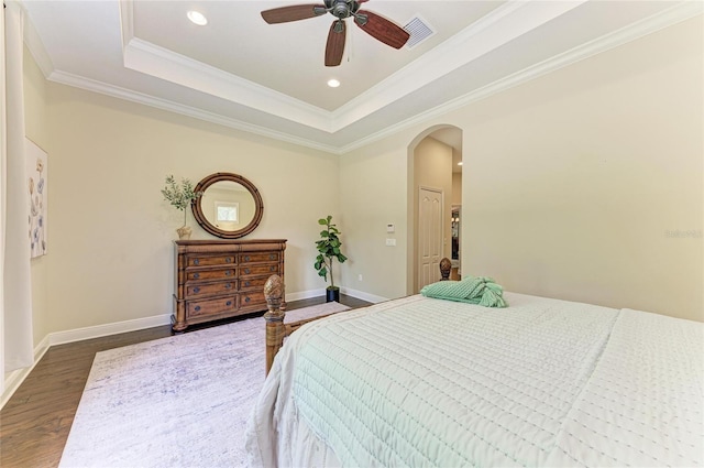 7278 Lismore Ct, Lakewood Ranch, FL 34202 - bedroom with arched walkways, dark wood-style flooring, crown molding, recessed lighting, and baseboards
