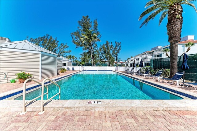 5055 Gulf Of Mexico Dr Unit 422, Longboat Key, FL 34228 - community pool featuring a patio and fence