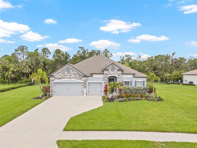 2707 162nd Ave E, Parrish, FL 34219 - french country home featuring a front lawn, stone siding, driveway, a garage, and view of wooded area