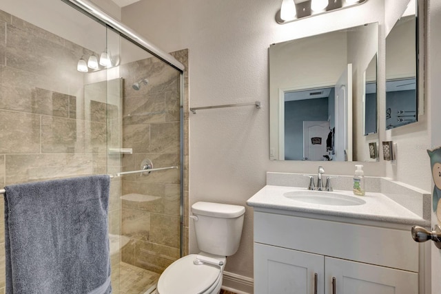 2707 162nd Ave E, Parrish, FL 34219 - bathroom with toilet, vanity, a shower stall, and a textured wall