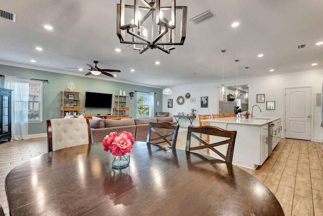 2707 162nd Ave E, Parrish, FL 34219 - dining room featuring ornamental molding, recessed lighting, ceiling fan, baseboards, and a chandelier