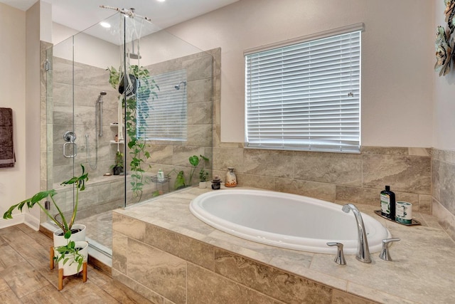2707 162nd Ave E, Parrish, FL 34219 - full bathroom featuring a garden tub, a stall shower, and wood finished floors