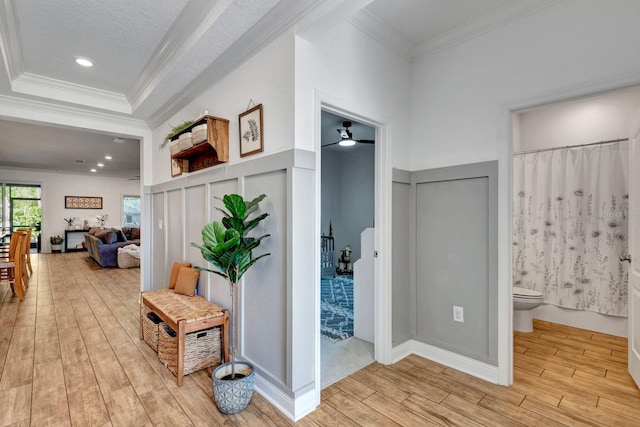 2707 162nd Ave E, Parrish, FL 34219 - hallway featuring light wood-type flooring, crown molding, recessed lighting, and a decorative wall