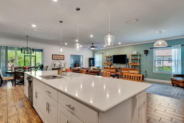 2707 162nd Ave E, Parrish, FL 34219 - kitchen featuring a sink, open floor plan, recessed lighting, ornamental molding, and white cabinets