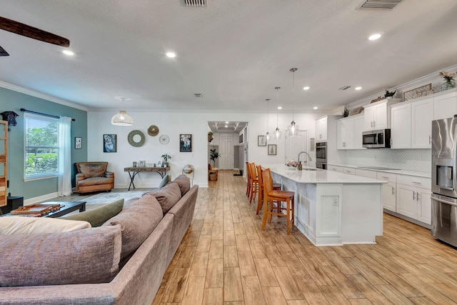 2707 162nd Ave E, Parrish, FL 34219 - living area featuring ornamental molding, light wood-style floors, recessed lighting, and baseboards