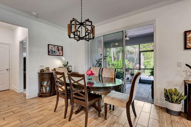 2707 162nd Ave E, Parrish, FL 34219 - dining space featuring ornamental molding, light wood-style floors, a chandelier, and baseboards
