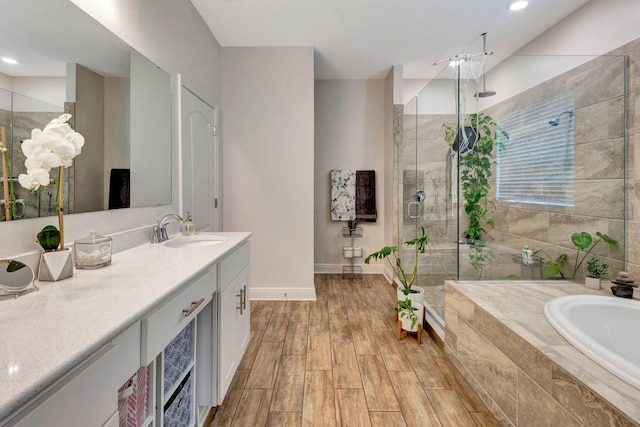 2707 162nd Ave E, Parrish, FL 34219 - full bathroom with a stall shower, vanity, a garden tub, baseboards, and recessed lighting