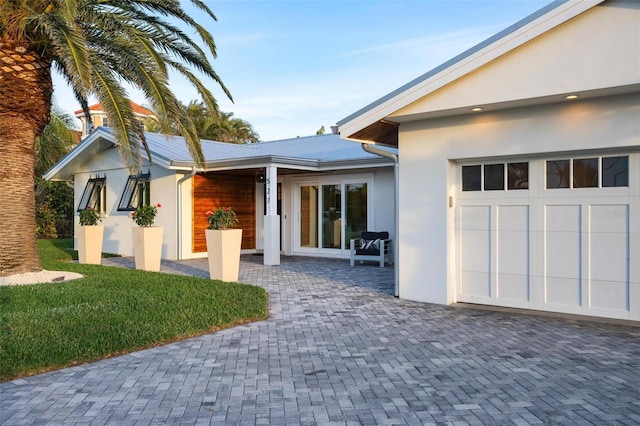 527 Key Royale Dr, Holmes Beach, FL 34217 - view of front of home with a garage and stucco siding