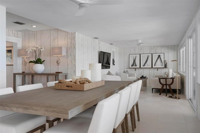 527 Key Royale Dr, Holmes Beach, FL 34217 - dining space with wood walls, ceiling fan, and visible vents