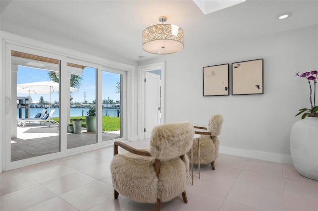 527 Key Royale Dr, Holmes Beach, FL 34217 - interior space featuring baseboards, a water view, recessed lighting, a skylight, and light tile patterned flooring