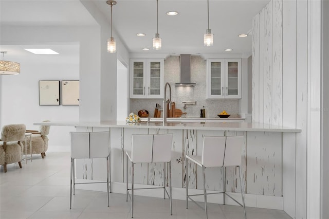 527 Key Royale Dr, Holmes Beach, FL 34217 - kitchen with backsplash, recessed lighting, a kitchen breakfast bar, and decorative light fixtures