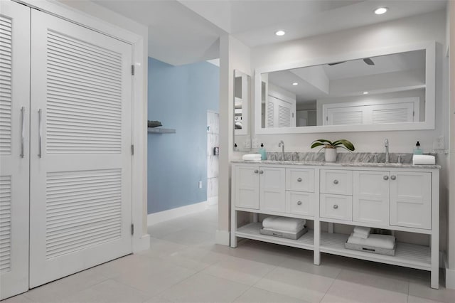 527 Key Royale Dr, Holmes Beach, FL 34217 - full bathroom featuring tile patterned flooring, double vanity, baseboards, and a sink