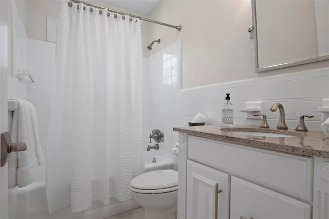 527 Key Royale Dr, Holmes Beach, FL 34217 - bathroom with toilet, tile walls, shower / tub combo with curtain, vanity, and wainscoting
