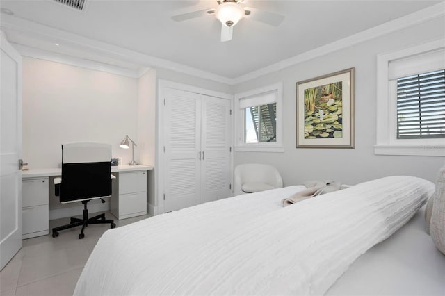 527 Key Royale Dr, Holmes Beach, FL 34217 - bedroom featuring light tile patterned floors, a closet, ornamental molding, and a ceiling fan