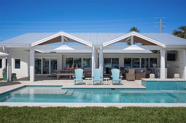 527 Key Royale Dr, Holmes Beach, FL 34217 - rear view of property with a patio area, metal roof, and an outdoor pool