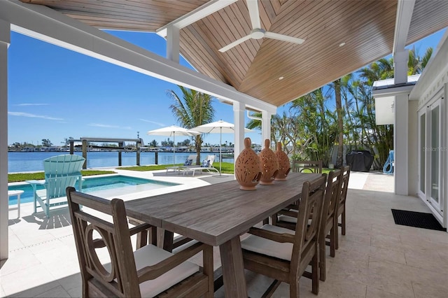 527 Key Royale Dr, Holmes Beach, FL 34217 - view of patio featuring a water view, ceiling fan, outdoor dining area, and an outdoor pool