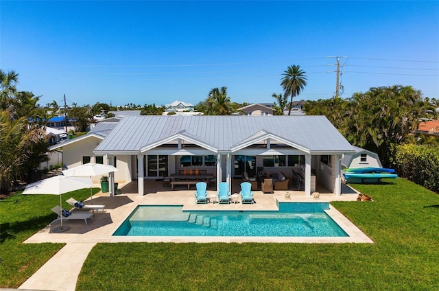 527 Key Royale Dr, Holmes Beach, FL 34217 - back of property with an outdoor pool, a patio, and a yard