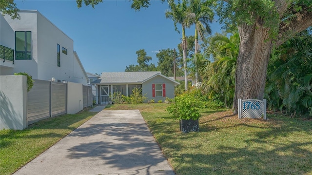 view of front of house featuring a front yard, stucco siding, and fence