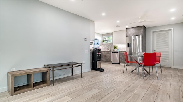 kitchen featuring a ceiling fan, light countertops, light wood finished floors, and appliances with stainless steel finishes