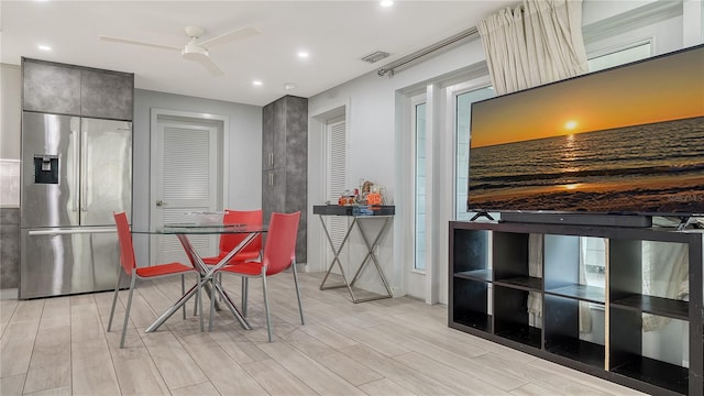 dining room with light wood finished floors, ceiling fan, visible vents, and recessed lighting