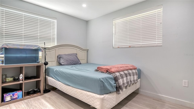 bedroom featuring baseboards and wood finished floors